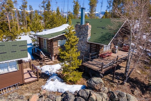 view of home's exterior featuring a wooden deck and log exterior