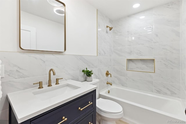 full bathroom with vanity, shower / bathing tub combination, toilet, and tile walls