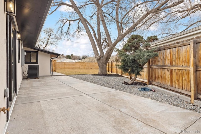 view of patio with central AC and a fenced backyard