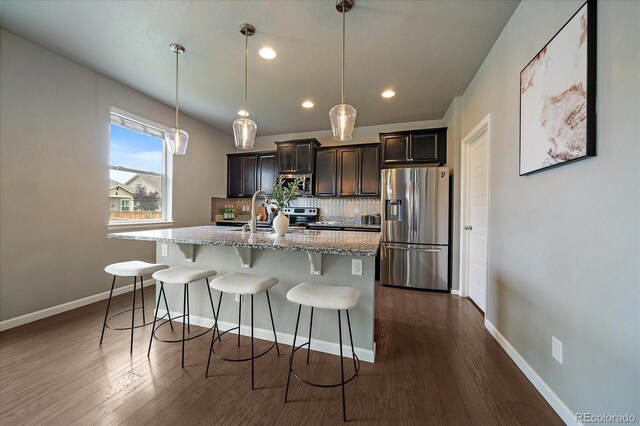 1181 W 170th Ave, Broomfield, CO 80023 - kitchen with stainless steel appliances, decorative backsplash, a kitchen breakfast bar, dark wood-style floors, and recessed lighting