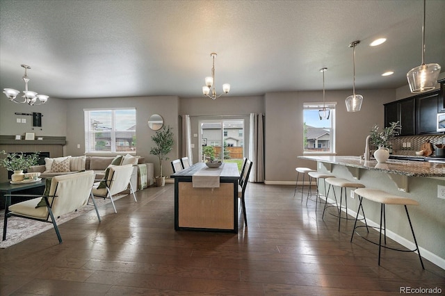 1181 W 170th Ave, Broomfield, CO 80023 - kitchen with a chandelier, healthy amount of natural light, a kitchen island with sink, a breakfast bar area, and recessed lighting