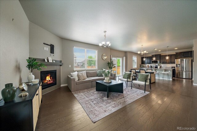 1181 W 170th Ave, Broomfield, CO 80023 - living area with a chandelier, dark wood-style flooring, a fireplace, baseboards, and recessed lighting