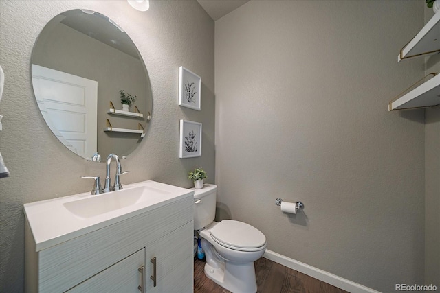1181 W 170th Ave, Broomfield, CO 80023 - bathroom featuring wood finished floors, vanity, toilet, and baseboards