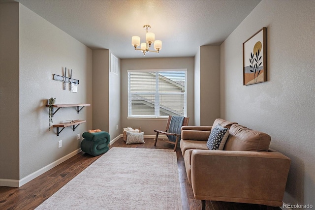 1181 W 170th Ave, Broomfield, CO 80023 - sitting room featuring a chandelier, wood finished floors, baseboards, and a textured wall