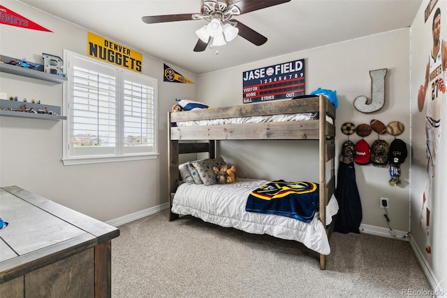 carpeted bedroom featuring baseboards and a ceiling fan