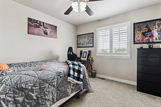 carpeted bedroom with baseboards, visible vents, and a ceiling fan