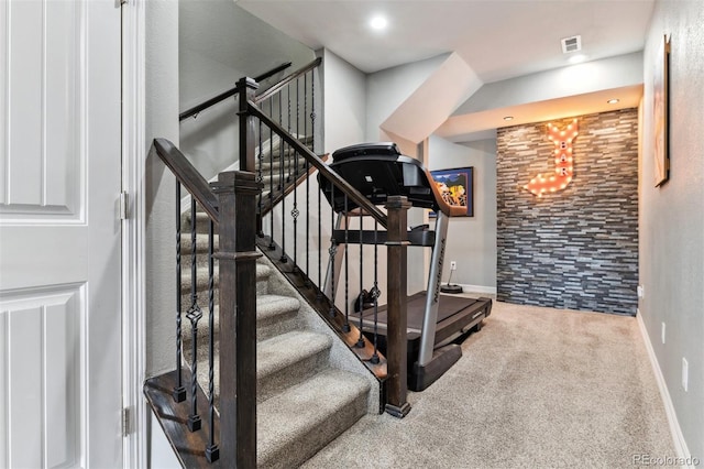 staircase with baseboards, visible vents, and carpet