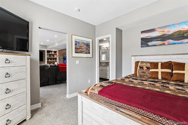 bedroom featuring light carpet, ensuite bath, baseboards, and recessed lighting
