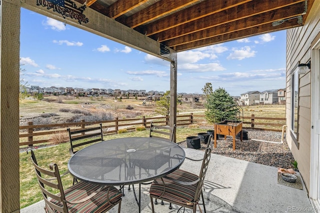 view of patio with fence and outdoor dining space
