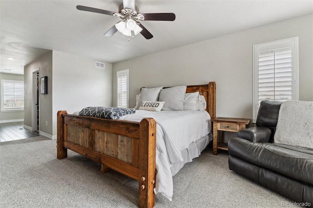 bedroom with baseboards, visible vents, carpet, and a ceiling fan