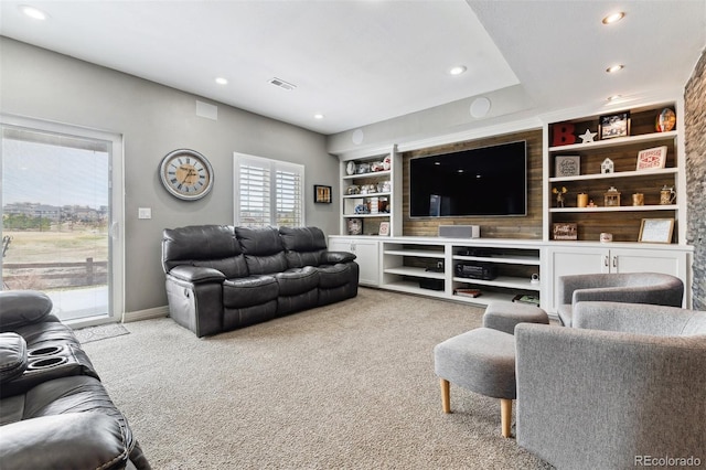 carpeted living room featuring baseboards, built in shelves, visible vents, and recessed lighting