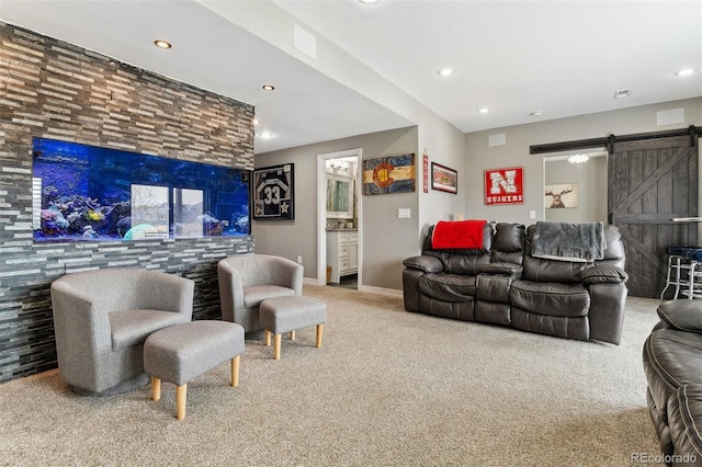 living area with carpet floors, a barn door, and recessed lighting