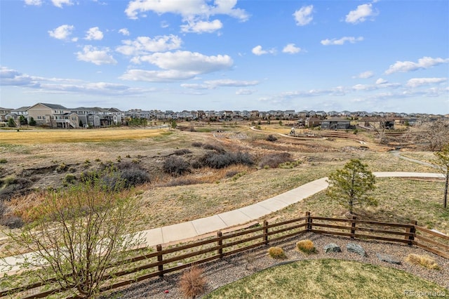 view of yard featuring fence and a residential view