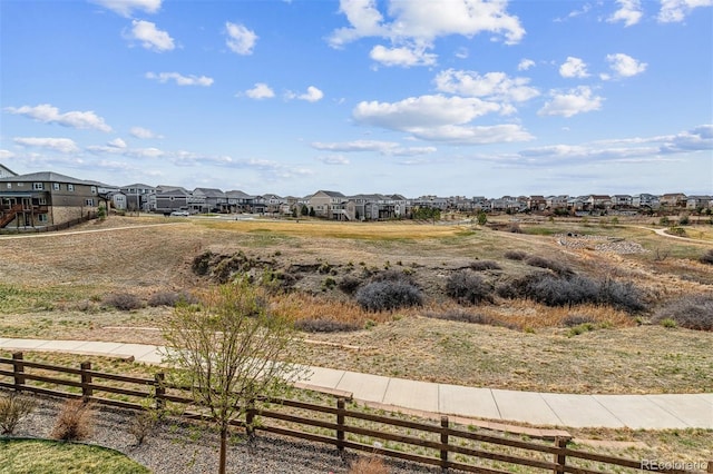 view of yard featuring fence and a residential view