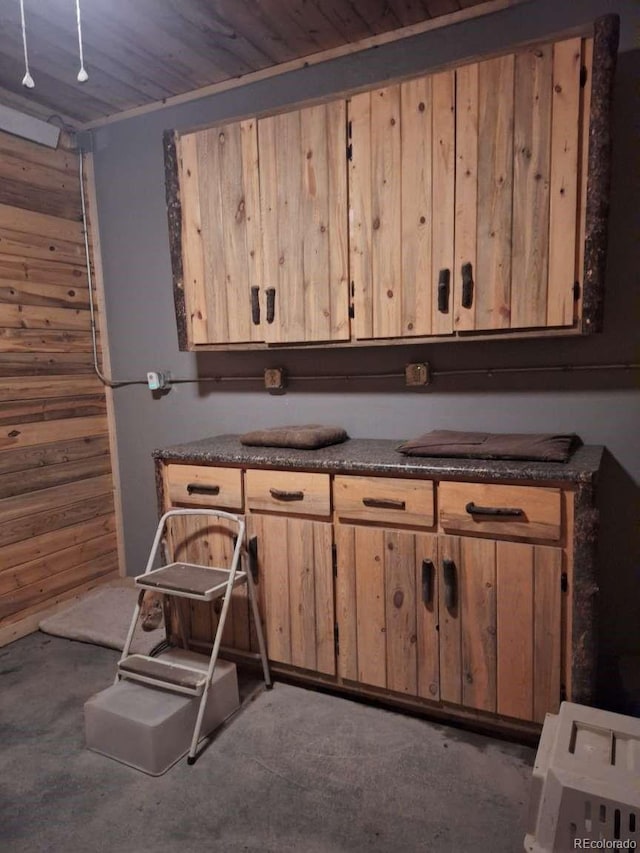 kitchen featuring wood ceiling and wood walls