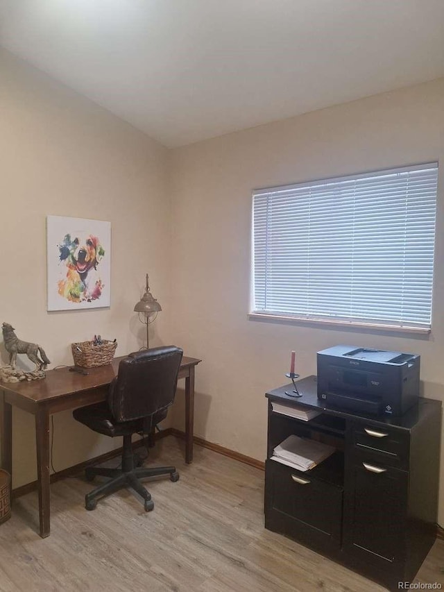 office with light wood-type flooring