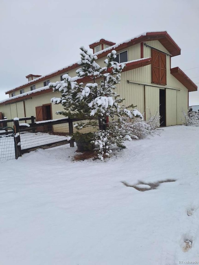 view of snow covered exterior featuring an outdoor structure