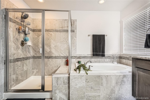 bathroom featuring a shower stall, vanity, a bath, and recessed lighting