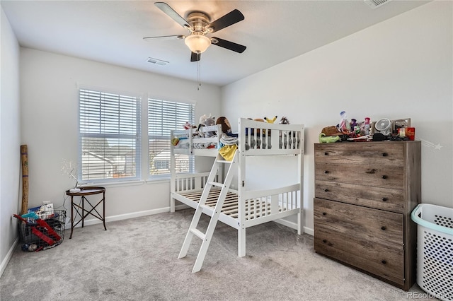 bedroom with visible vents, light carpet, and baseboards