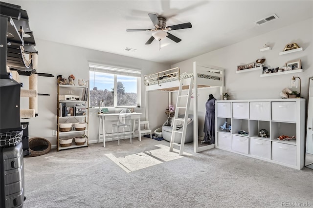 bedroom with light colored carpet, visible vents, and ceiling fan