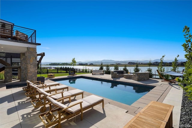 view of pool featuring a water and mountain view, outdoor lounge area, and a patio area