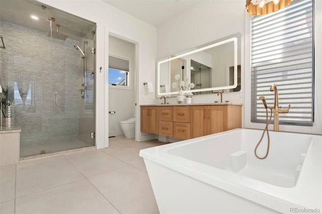 full bathroom with tile patterned flooring, vanity, separate shower and tub, and toilet