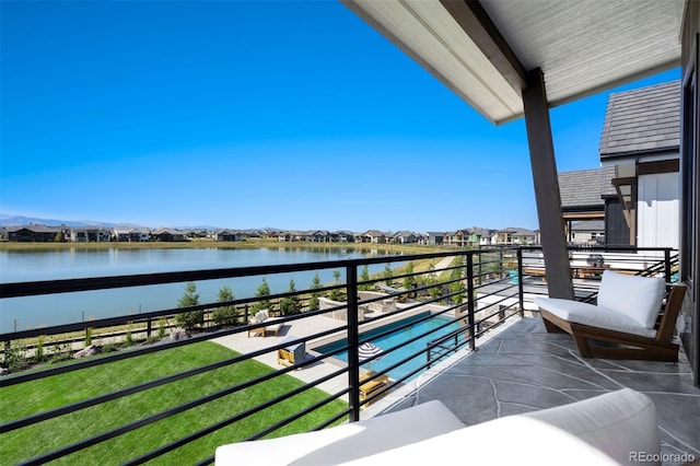 balcony featuring a water and mountain view