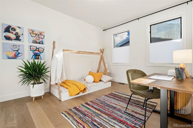 home office with wood-type flooring