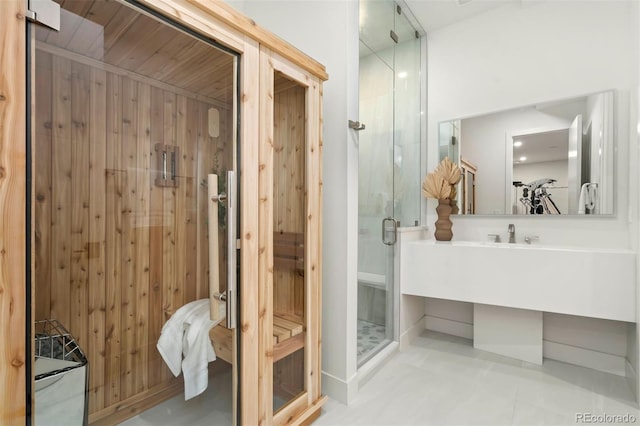 bathroom with walk in shower, vanity, and wooden walls