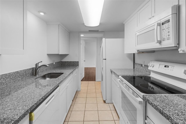 kitchen with sink, white cabinetry, white appliances, and light tile patterned floors