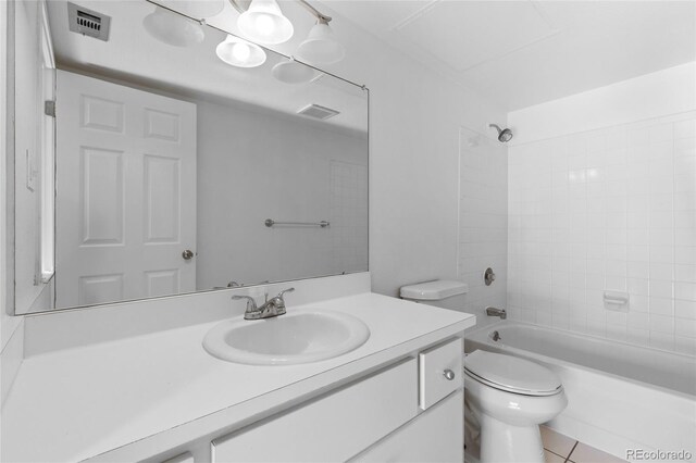 full bathroom with vanity, toilet, tile patterned floors, and tiled shower / bath combo