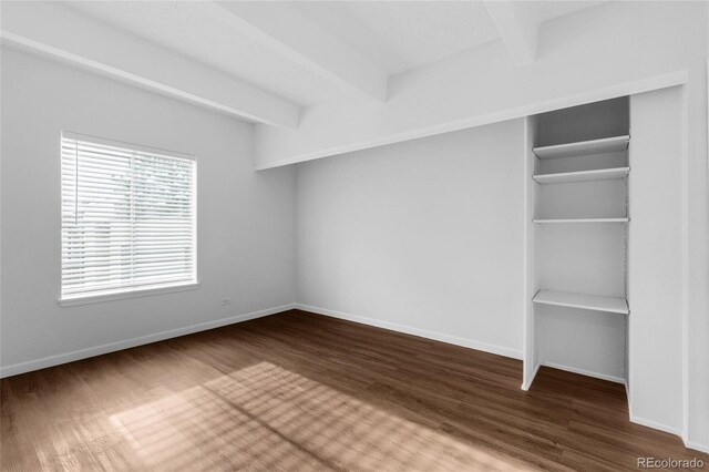 interior space featuring beam ceiling and hardwood / wood-style flooring