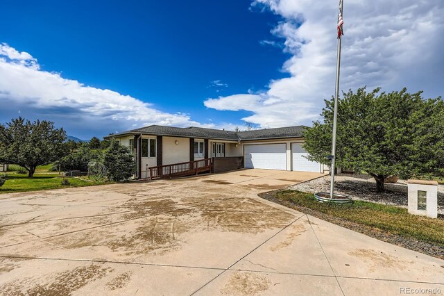 16710 Vincent Ave, Monument, CO 80132 - view of front of house with a garage, driveway, stucco siding, and covered porch
