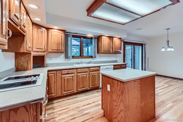 16710 Vincent Ave, Monument, CO 80132 - kitchen with white appliances, a kitchen island, light wood-style floors, light countertops, and recessed lighting
