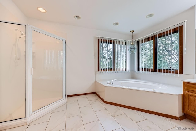 16710 Vincent Ave, Monument, CO 80132 - bathroom featuring a stall shower, healthy amount of natural light, a garden tub, vanity, and recessed lighting