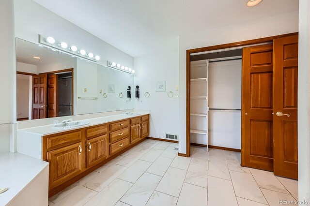 16710 Vincent Ave, Monument, CO 80132 - full bath featuring marble finish flooring, double vanity, and a spacious closet