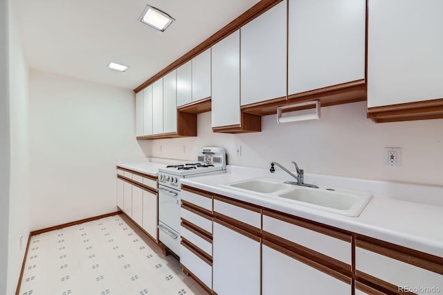 16710 Vincent Ave, Monument, CO 80132 - kitchen featuring white gas range, light countertops, light flooring, and white cabinetry