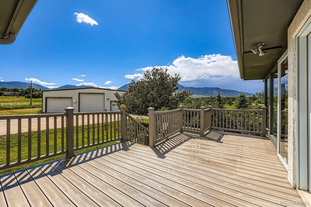 16710 Vincent Ave, Monument, CO 80132 - wooden terrace with a mountain view, an outdoor structure, a detached garage, and a yard