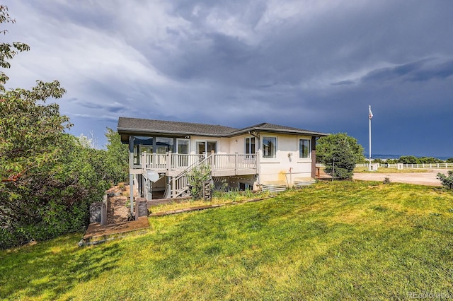 16710 Vincent Ave, Monument, CO 80132 - back of house featuring a lawn, a wooden deck, stairs, and stucco siding
