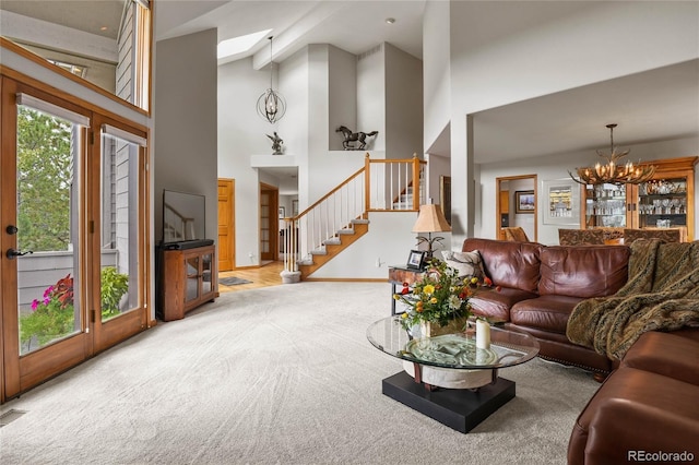 carpeted living room featuring high vaulted ceiling and a chandelier