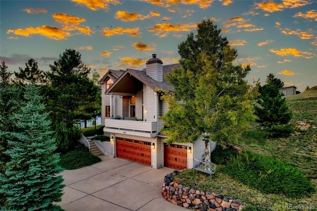 386 Monte Vista Rd, Golden, CO 80401 - contemporary house with an attached garage, driveway, and a chimney