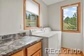 386 Monte Vista Rd, Golden, CO 80401 - washroom featuring independent washer and dryer and cabinet space