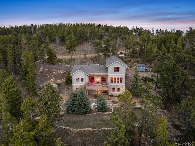 1055 Divide View Dr, Golden, CO 80403 - aerial view at dusk featuring a view of trees