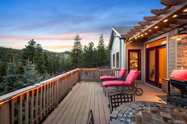1055 Divide View Dr, Golden, CO 80403 - deck at dusk with area for grilling and outdoor dining area