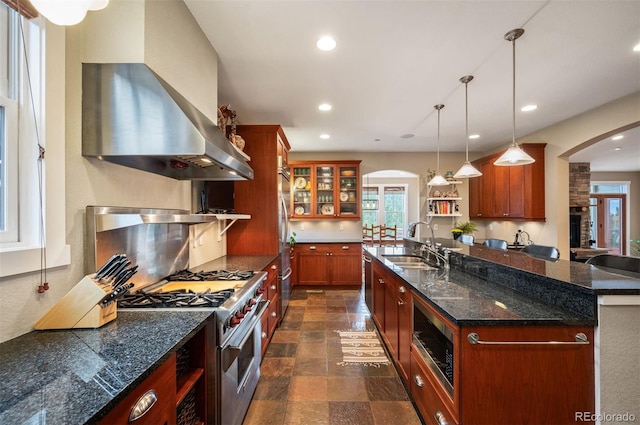 1055 Divide View Dr, Golden, CO 80403 - kitchen with arched walkways, a sink, appliances with stainless steel finishes, and ventilation hood