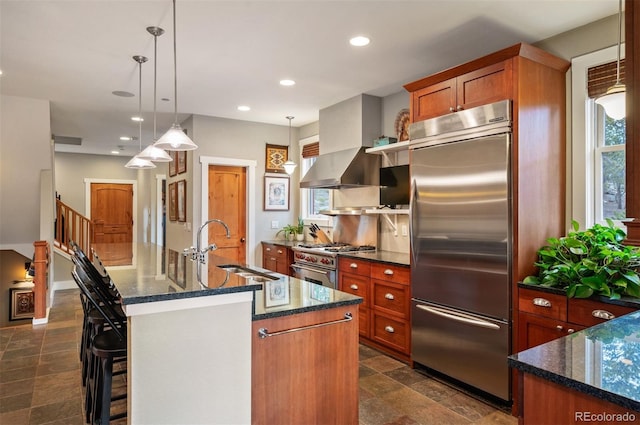 1055 Divide View Dr, Golden, CO 80403 - kitchen with stone finish floor, high end appliances, brown cabinetry, and a sink