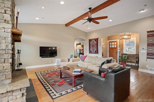 1055 Divide View Dr, Golden, CO 80403 - living area featuring arched walkways, ceiling fan, lofted ceiling with beams, and wood finished floors