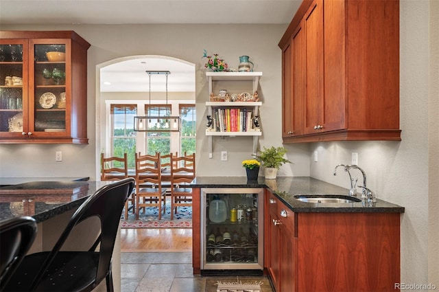 1055 Divide View Dr, Golden, CO 80403 - bar featuring a sink, arched walkways, and beverage cooler