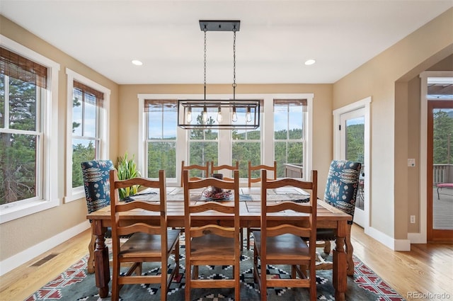 1055 Divide View Dr, Golden, CO 80403 - dining space featuring light wood-style floors, baseboards, visible vents, and a chandelier