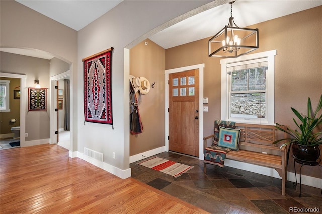 1055 Divide View Dr, Golden, CO 80403 - foyer entrance with visible vents, arched walkways, baseboards, a notable chandelier, and a wealth of natural light